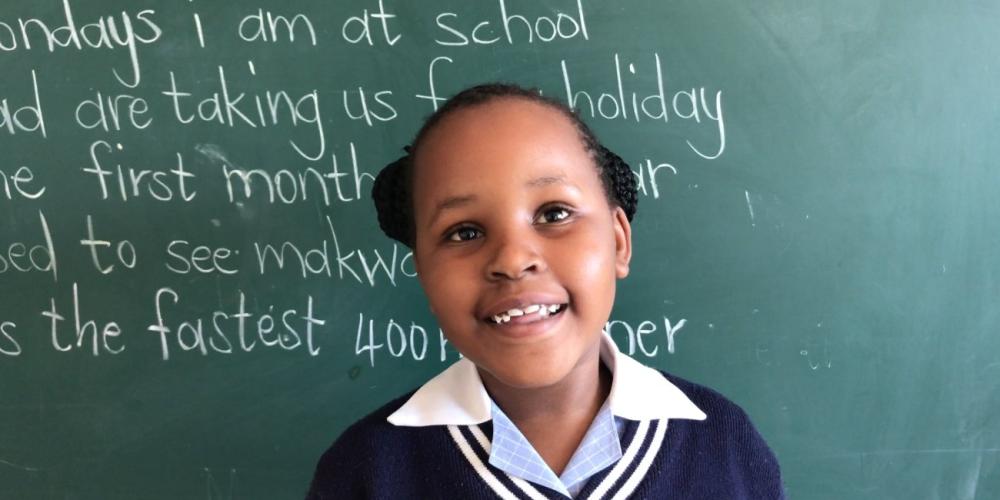 Tebogo Sebego, 7, standing in her classroom at Eastern Gate Academy in Francistown, Botswana. (Andrew McChesney / Adventist Mission)