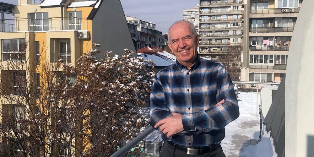 Jivko Grushev, 69, standing on a balcony at the headquarters of the Seventh-day Adventist Church in Bulgaria in Sofia. (Andrew McChesney / Adventist Mission)