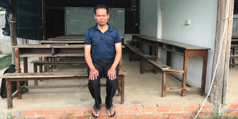 Sorn Som An, 40, sharing his story near the site of the future community center in Battambang, Cambodia. (Andrew McChesney / Adventist Mission)