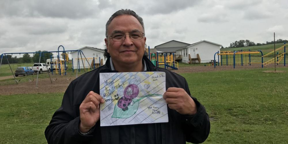 Daniel Guiboshe, 56, holding the picture drawn by 11-year-old Jojo Wolfe. (Photos: Andrew McChesney / Adventist Mission)