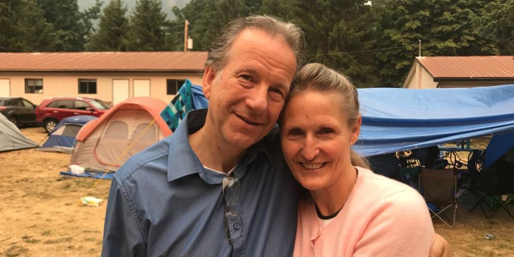 Dave Beaven embracing his wife, Debbie, at the Hope Camp Meeting in Hope, British Columbia. (Andrew McChesney / Adventist Mission)