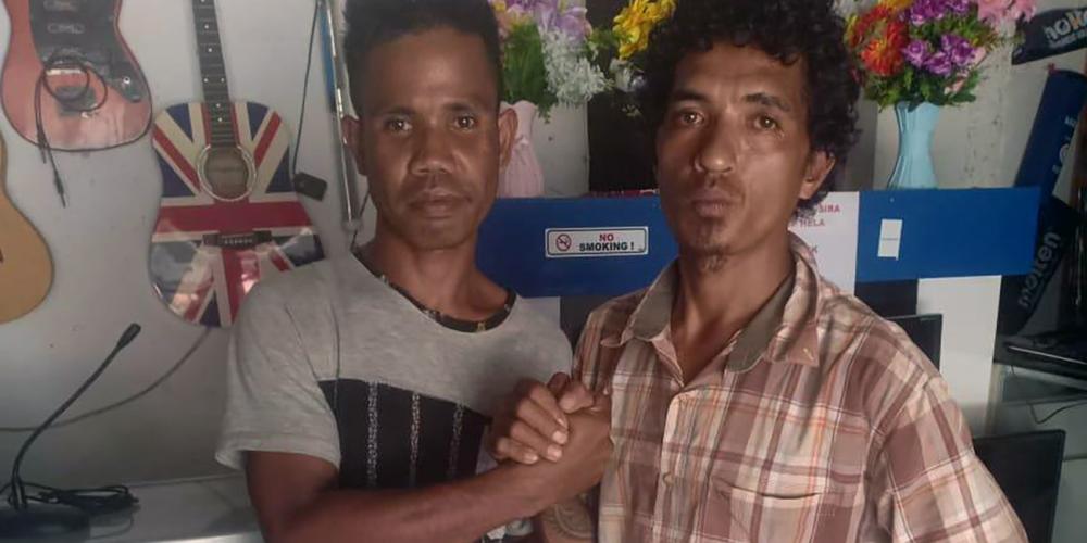 Seventh-day Adventist store clerk Edu Wachumura, left, embracing his would-be killer, Juvinil Ananias, in Lospalos, East Timor, on March 20, 2019. (Zelindo João Lay / For Adventist Mission)
