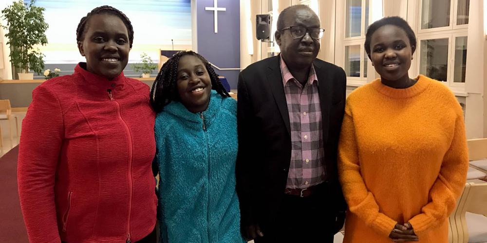 Bilha Tuitoek, 17, right, standing with her mother, Sally, left; sister, Beryl; and father, Jackson, in Tempere Central Seventh-day Adventist Church in Tempere, Finland. (Andrew McChesney / Adventist Mission)