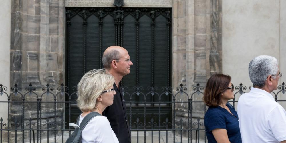 Ted and Nancy Wilson, left, and Williams and Sonete Costa passing a church door that commemorates Martin Luther’s 95 theses in Wittenberg, Germany. (Matthias Müller / ADAMS)