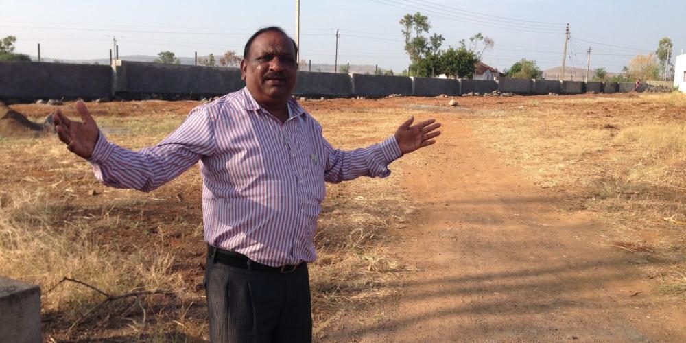 Manohar Karnad, principal of the Alate Seventh-day Adventist School in India, showing the location for the new block of classrooms. (Andrew McChesney / Adventist Mission)