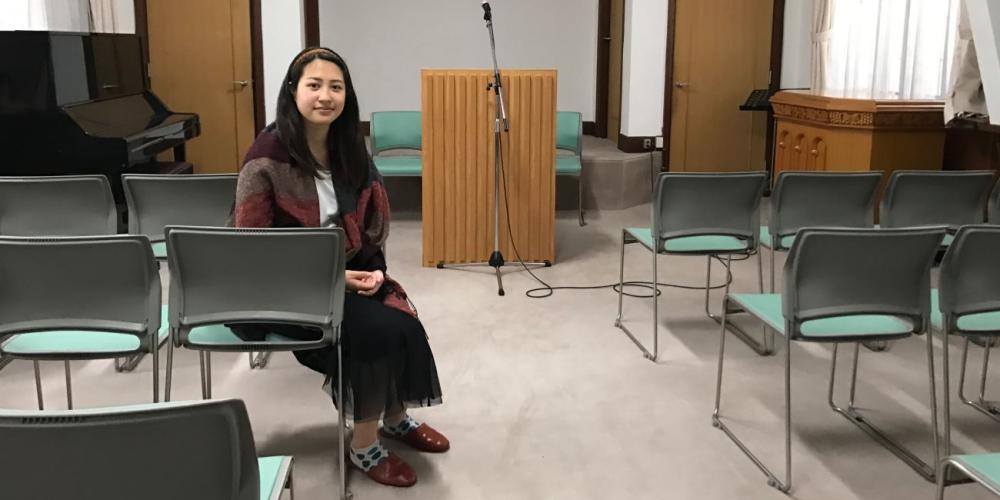 Horita Risa, 24, sitting in the only youth church in Japan, the Setagaya Church in Tokyo. The church will receive funds from the Thirteenth Sabbath Offering next year to expand its youth program. (Andrew McChesney / Adventist Mission)