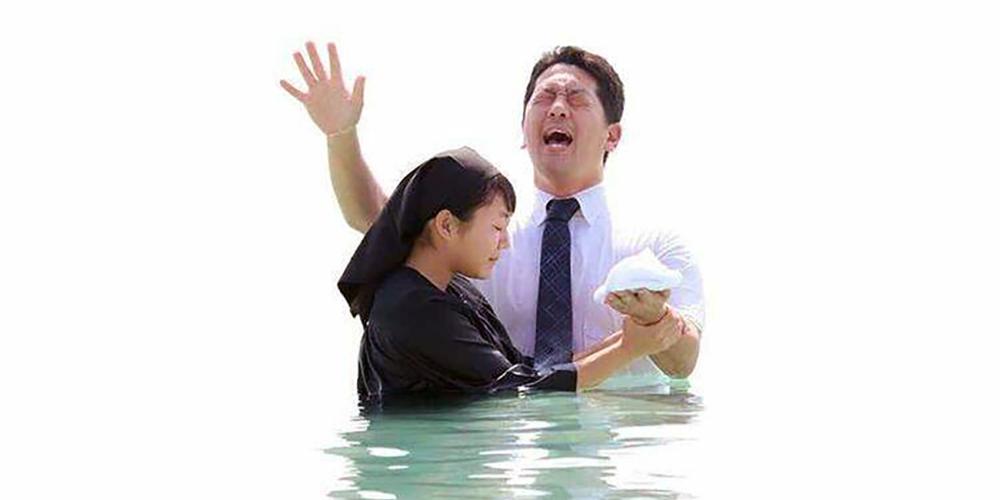 Seventh-day Adventist pastor Ken Matsuda baptizing 15-year-old Nana Honzawa in Okinawa, Japan. 'I personally don’t have any problem sharing the gospel with non-Christians, who comprise the majority of Japan’s population,' he says. 'But the hardest thing for me is the fact that many people are secular.' Photo courtesy of Ken Matsuda