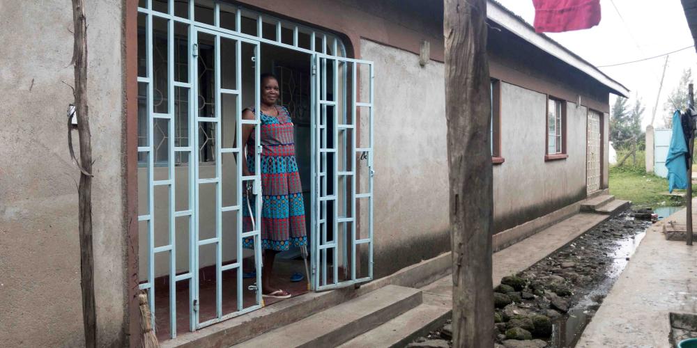 Phylis Odindo, 45, standing at the entrance of her home in Kisumu, Kenya. (Andrew McChesney / Adventist Mission)