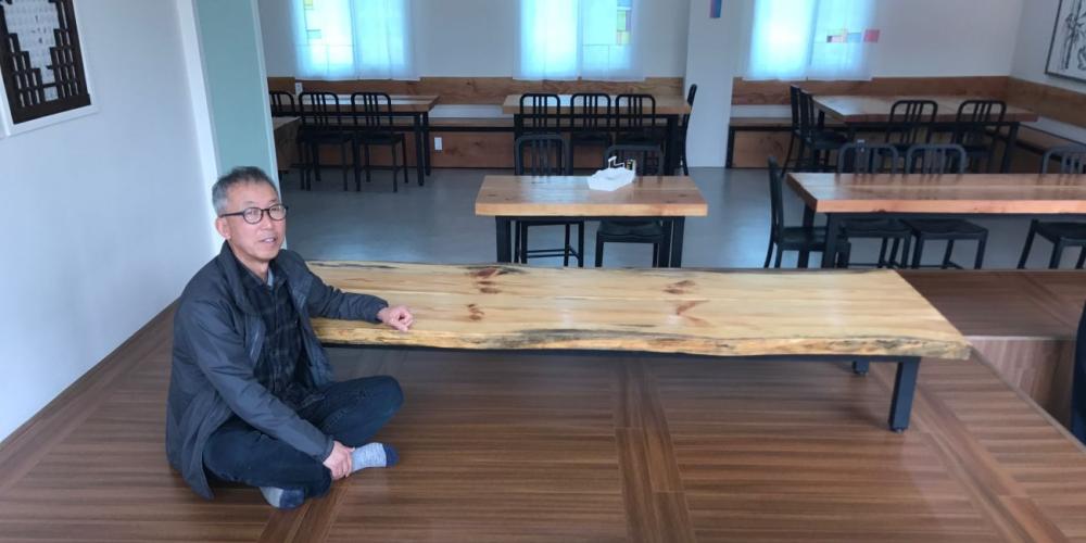 Takyoung “Chris” Lee sitting in the fellowship hall that he refurbished in an Adventist church in Chuncheon, South Korea. (Photos: Andrew McChesney)