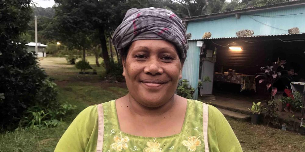 Sophie Buama, 44, standing outside her home in Mebuet, a village on the tiny island of Maré in New Caledonia. (Andrew McChesney / Adventist Mission)