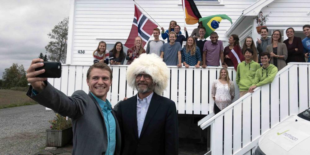 Jeremy Zwiker, left, chairman of the foundation that runs Matteson Mission School, taking a selfie with Adventist Church president Ted N.C. Wilson outside the school in Mysen, Norway, on Sept. 7, 2018. While meeting with the students, Wilson showed them a papakha, a wool hat worn by men in the Caucasus, that he received as a gift while visiting southern Russia shortly before arriving in Norway. (Andrew McChesney / Adventist Mission)