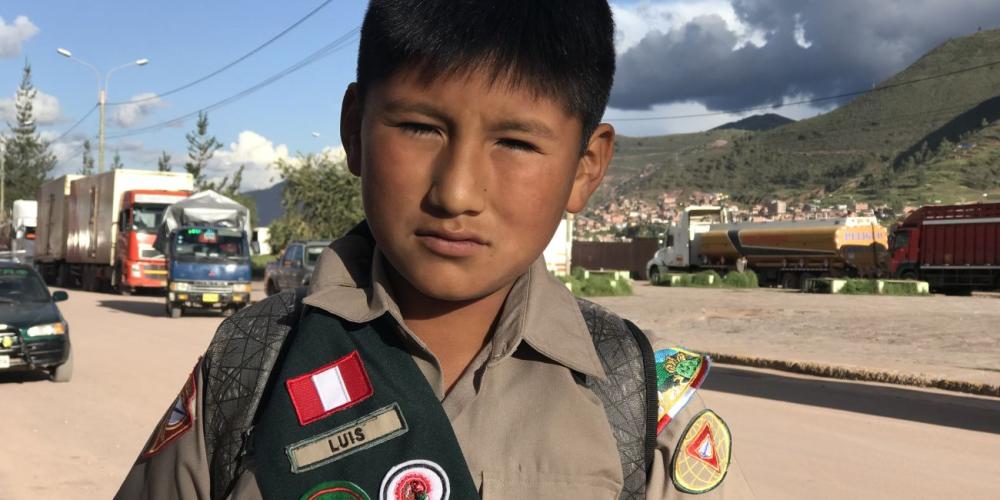 Luis Antonio Mendoza Condori, 11, standing in his Pathfinder uniform on a street in Cusco, Peru. (Andrew McChesney / Adventist Mission)