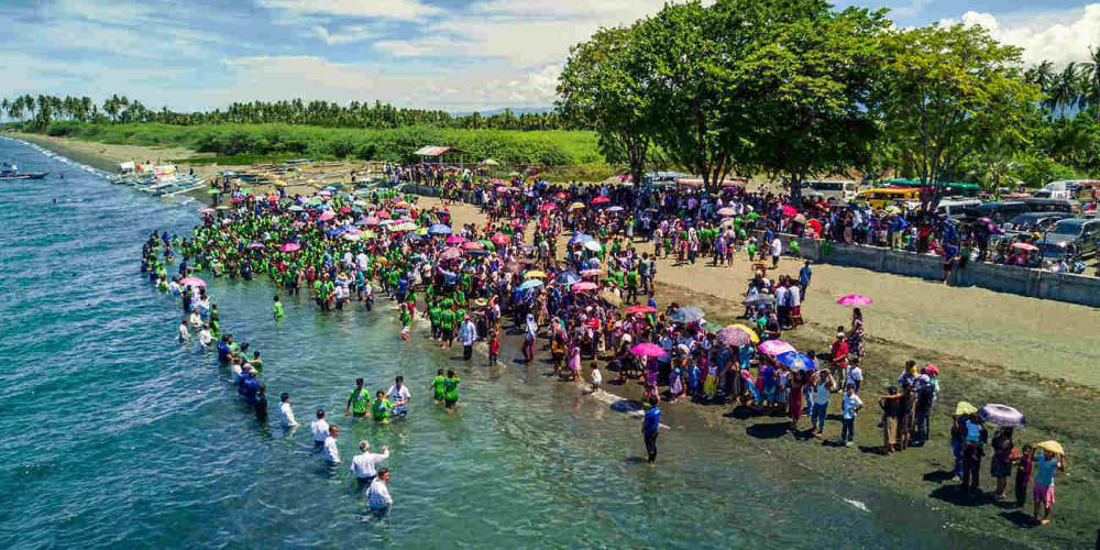 People being baptized on Mindoro Island in the Philippines on June 24, 2017. About 1,400 people were baptized after evangelistic meetings, which precede a countrywide campaign in 2018. (Nick Knecht / AWR)