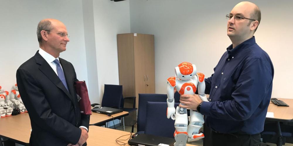 An instructor using a robot to demonstrate advances in artificial intelligence to Ted N.C. Wilson at University Politehnica of Bucharest in Bucharest, Romania, on July 11, 2017. (Andrew McChesney / Adventist Mission)