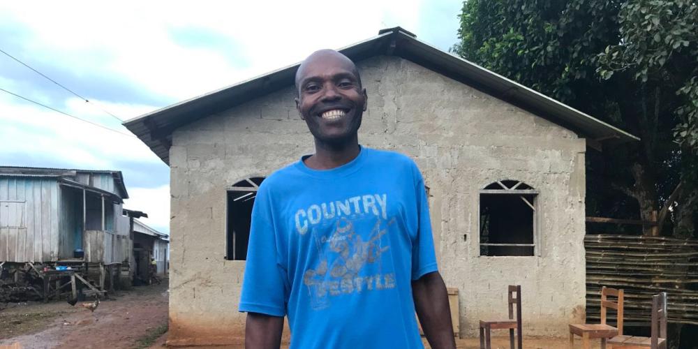 Constâncio Triste Afonso standing outside the Seventh-day Adventist church in the mountaintop village of Agua Sampaio in São Tomé and Príncipe. (Andrew McChesney / Adventist Mission) 