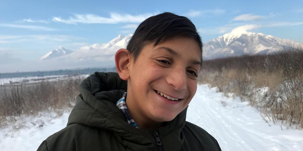 Samko Polhoš, 12, standing on the outskirts of Rakúsy, a Roma settlement of 2,000 people, in Slovakia. (Andrew McChesney / Adventist Mission)