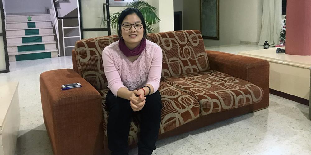 Sung Hye Choi, a South Korean born in Paraguay, sitting in the lobby of the girls’ dormitory at Sagunto Adventist College in Sagunto, Spain. Part of a Thirteenth Sabbath Offering in 1981 helped construct the girls' dormitory. (Andrew McChesney / Adventist Mission)