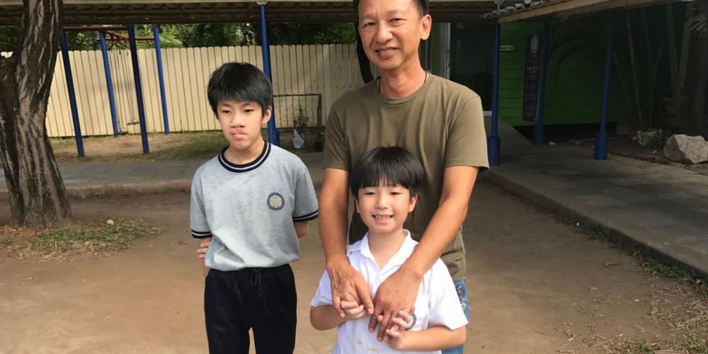 Thanakorn Pangputtipong, 53, with his sons Puri and Jeremy in Korat, Thailand. (Andrew McChesney / Adventist Mission)