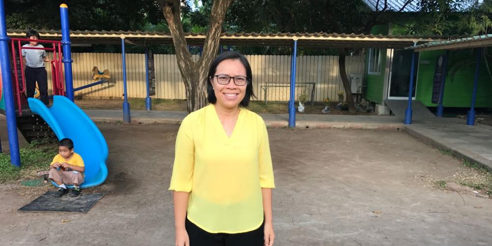 Saengsurin “Ann” Phongchan standing on the playground of the Adventist International Mission School - Korat in Thailand, where she is the principal. (Andrew McChesney / Adventist Mission)