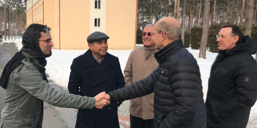 Adventist Church president Ted Wilson, second right, greeting lay evangelists from Mexico on an Adventist college campus in Bucha, Ukraine, on Feb. 2, 2017, as Euro-Asia Division president Michael Kaminskiy, right, watches. (Andrew McChesney / Adventist Mission)