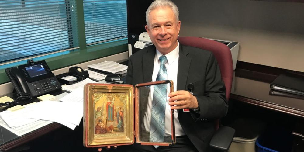 Guillermo Biaggi, a general vice president of the Seventh-day Adventist world church, showing an Orthodox icon in his office as the General Conference headquarters in Silver Spring, Maryland. (Andrew McChesney / Adventist Mission)
