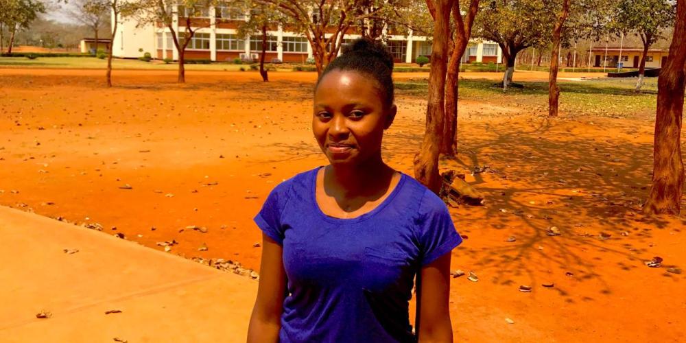 “God gave me life and is keeping me,” says Namoonga Masenke, pictured at Rusangu University in Zambia. (Andrew McChesney / Adventist Mission)