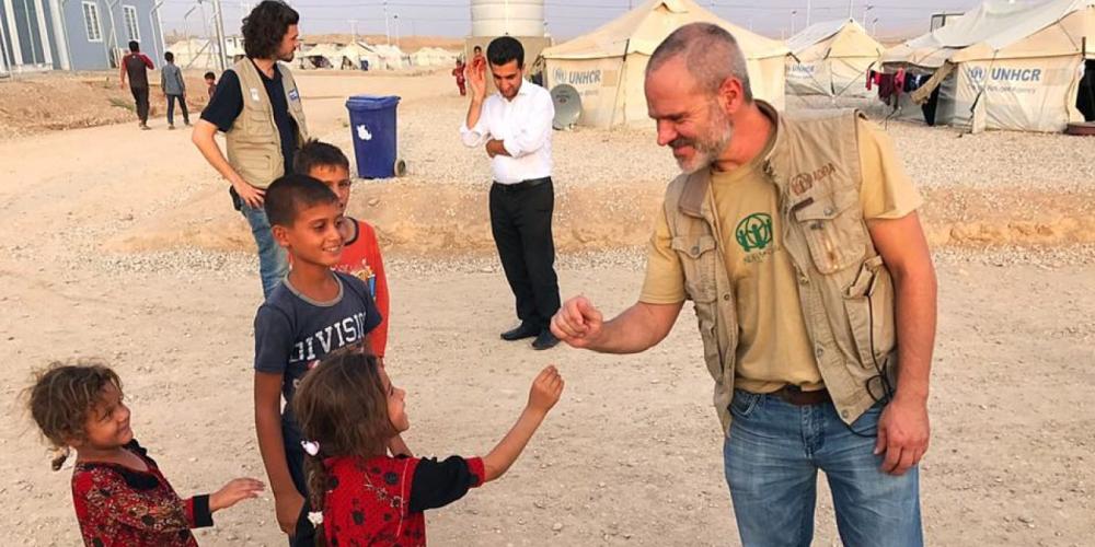 Marcelo Dornelles, 48, playing with displaced children at the Hasan Shami U2 camp near Mosul, Iraq. (Carolyn Azo / SAD)