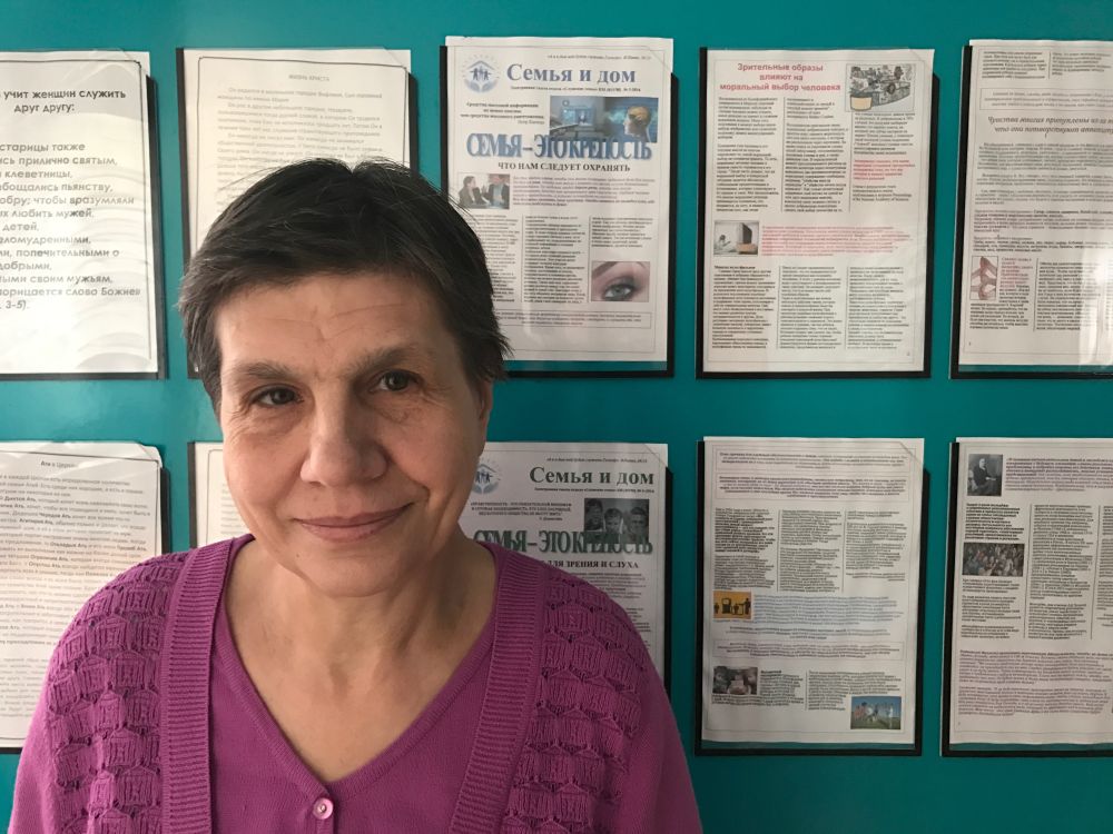 Tatyana Pashinko, pictured by a bulletin board in the Southern Seventh-day Adventist Church, says, “I never made a mistake in all my years of work, and I only got into trouble because I wanted to obey God.” (Andrew McChesney / Adventist Mission)