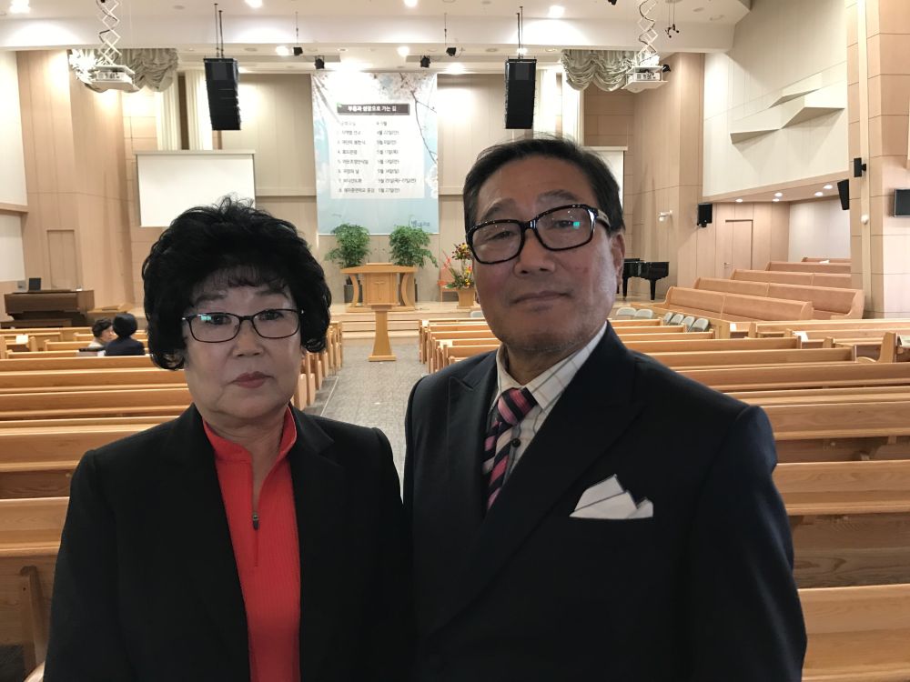 Pastors Ki-Jo Moon, right, and Soon-Ae Byun worshipping at the Byeollae Seventh-day Adventist Church in Seoul, South Korea, on April 22, 2017. They attended evangelistic meetings here in late 2016. (Andrew McChesney / Adventist Mission)