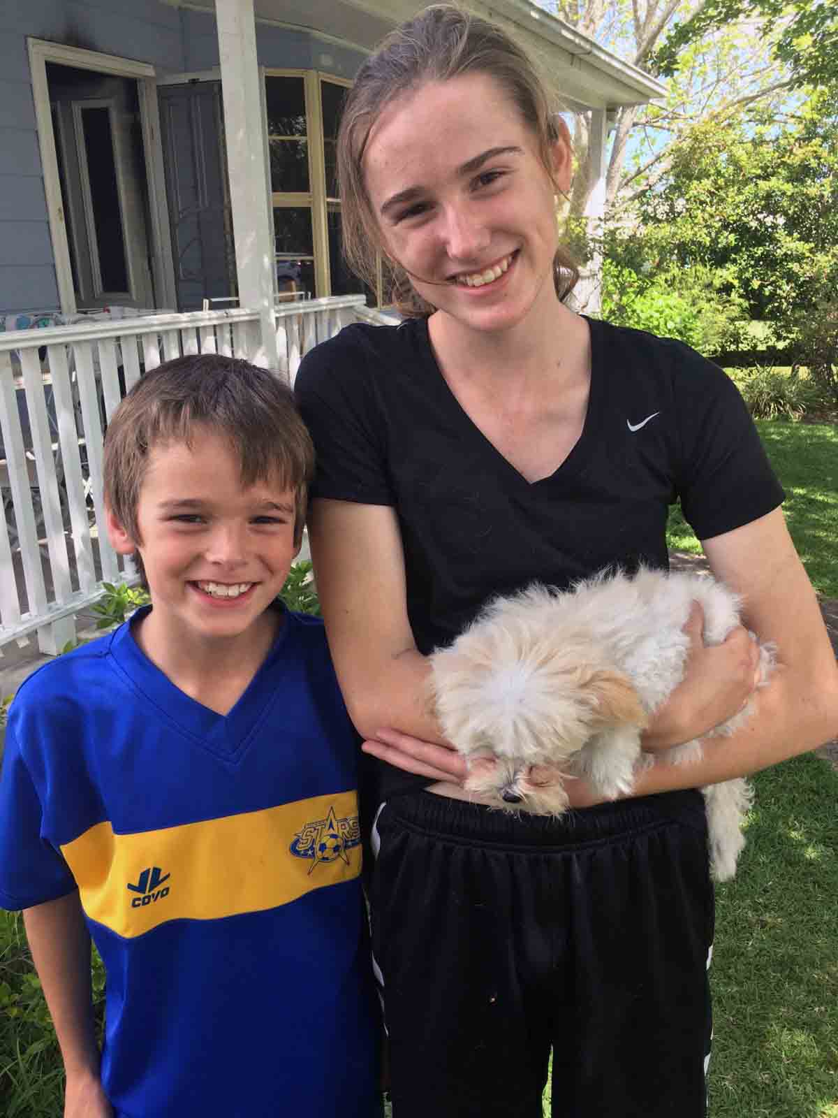 Lara Hawkins, 14, holding Milly after the fire as her brother, Jack, stands beside her. (Photo courtesy of the Hawkins family)
