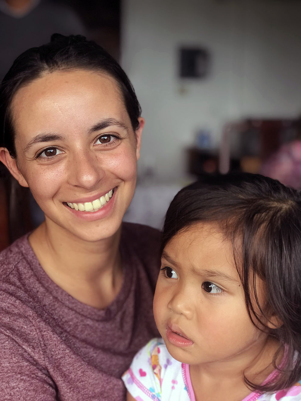 Melissa posing with a child during a visit to Palau in December 2018.
