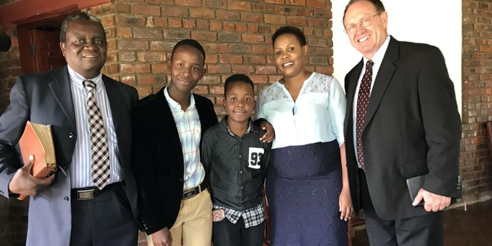 Eleven-year-old Mathew, center, with his mother and brother at an Adventist church in Harare, Zimbabwe, on Sabbath, April 22, 2017. Also pictured are Duane McKey, right, and Jonathan Muvoshi. (Courtesy of Duane McKey)